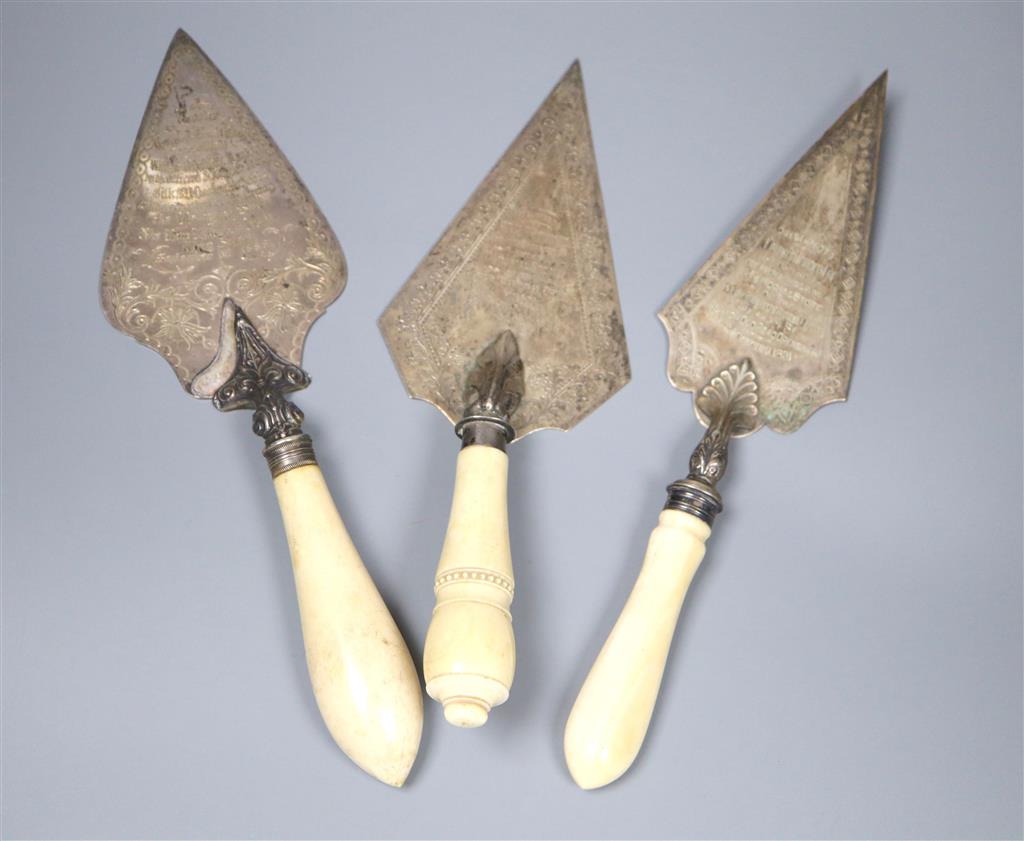 Two Victorian ivory handled silver presentation trowels, one a.f. and a similar plated trowel.